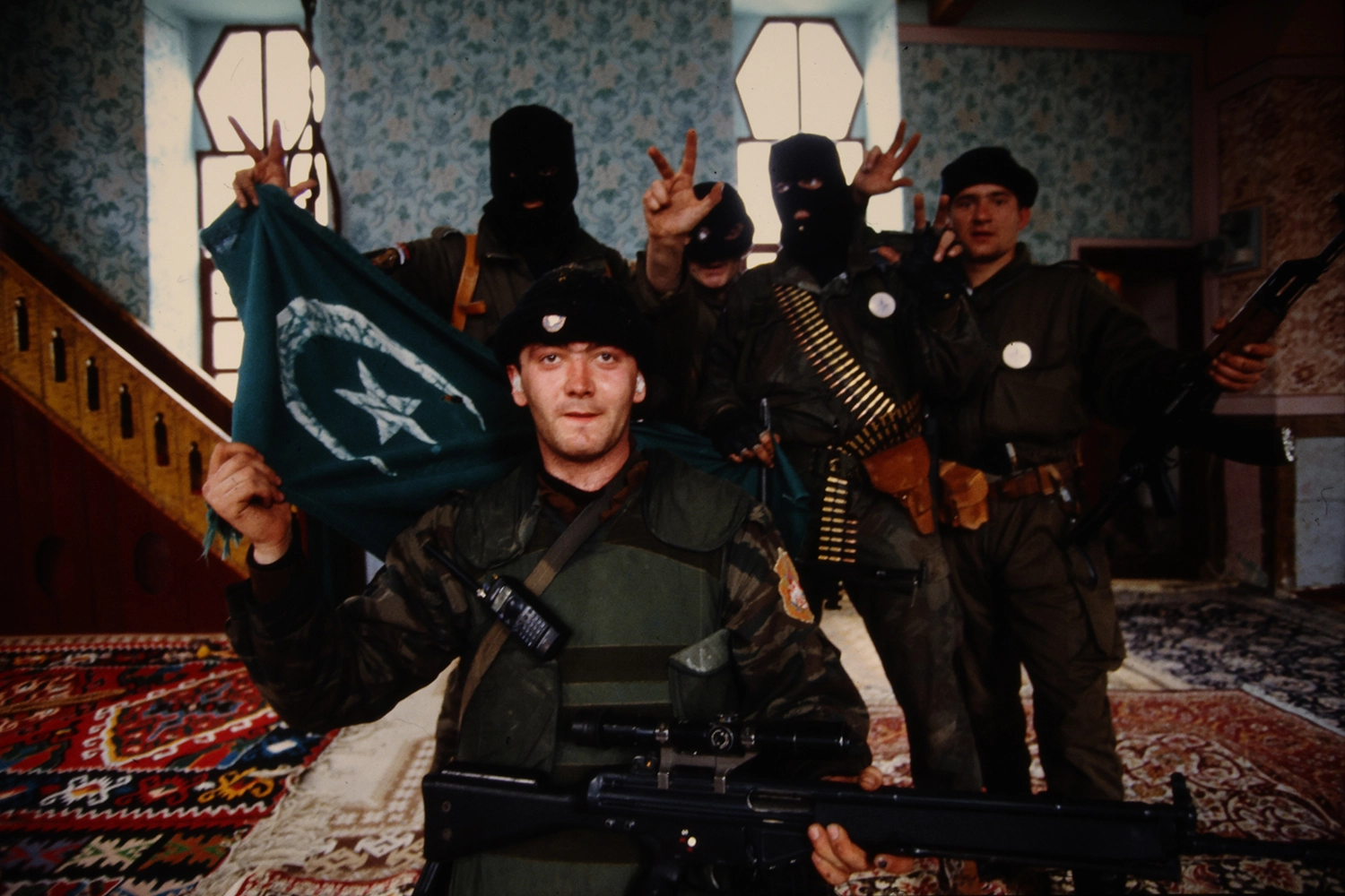 Members of Arkan's Tigers pose for a photograph in a looted mosque in Bijeljina on April 2, 1992.