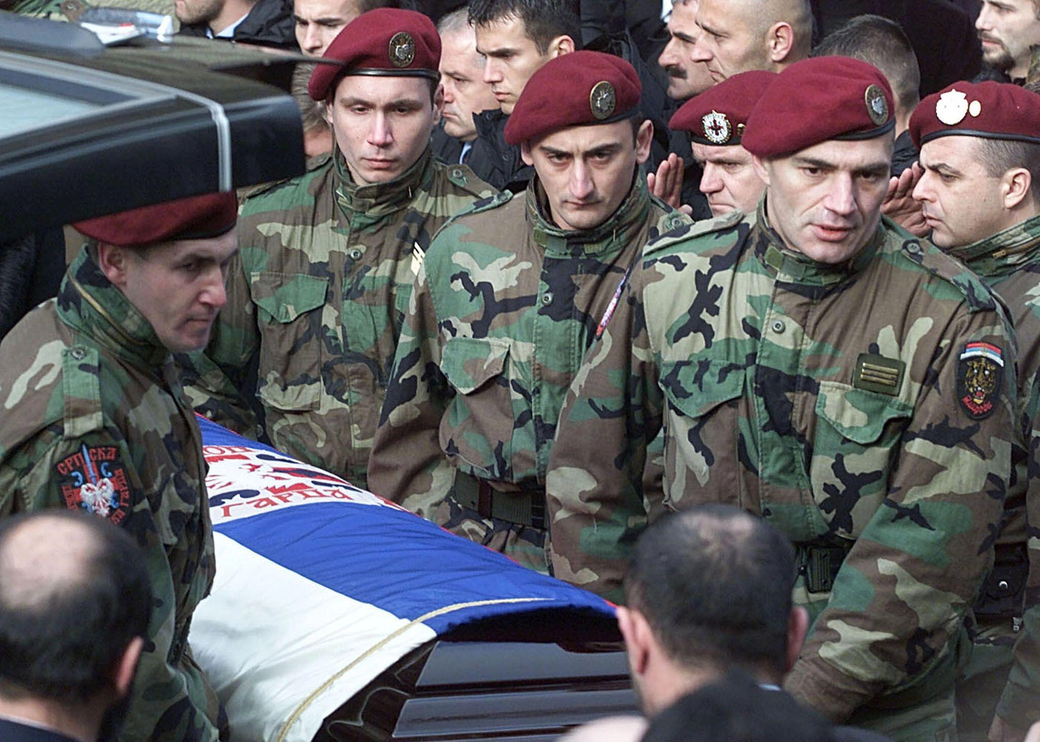 Members of Arkan's Tigers carry Arkan's coffin at his funeral in Belgrade, Serbia, on Jan. 20, 2000.